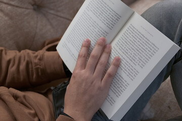 Man holding and reading a book 