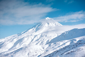 Plakat Winter landscape. Vilyuchinsky volcano covered with snow against blue sky. Kamchatka peninsula, Russia