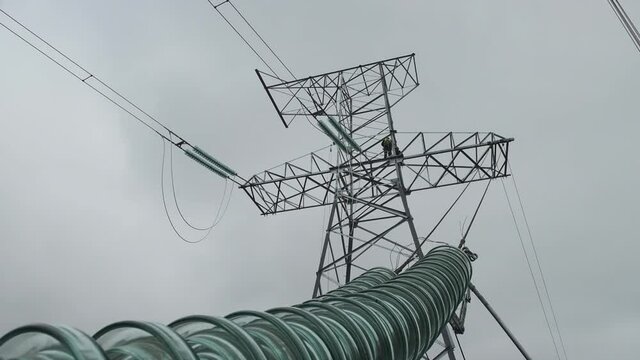 Installation of insulators on the mast of a high-voltage power line.