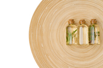 Bottle with essential oil and green leaf isolated on white background