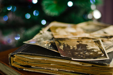Vintage photo album on christmas lights background. Family traditions and life values concept.