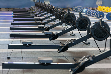 Group of Modern Black Rowing Machine at Gym: Fitness Equipment