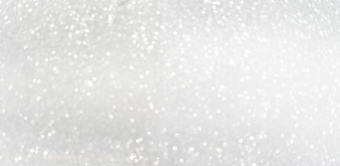 Defocused shining silver bokeh texture. Holiday background