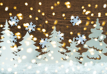Snow Christmas trees on a wooden background.