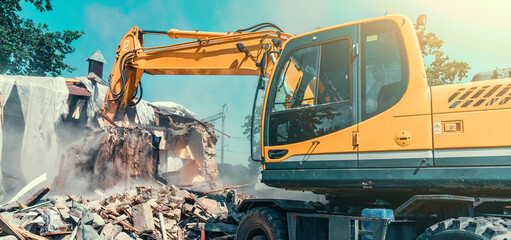 Excavator dismantling house on construction site. Demolition of dilapidated housing for new...