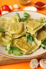 Delicious food concept with ravioli on orange background