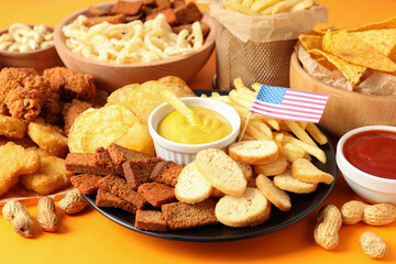 Concept of Super bowl snacks on orange  background
