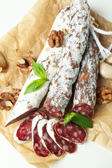 Сoncept of tasty food with salami sausage on white background