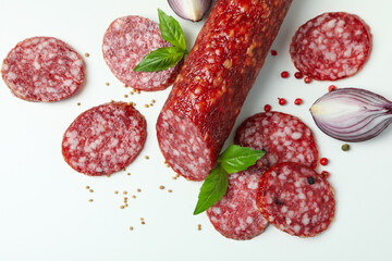 Сoncept of tasty food with salami sausage on white background