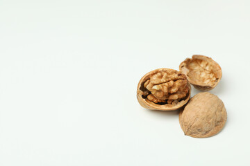 Walnuts with nutshell on white background, close up