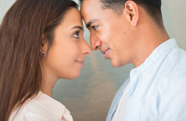 Love and romance concept people with young boy and girl looking in each other eyes touching front. Relationship and dating. Together romantic man and woman smiling