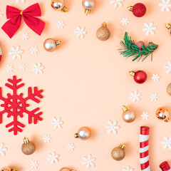 Christmas composition. Red and gold decorations on pastel pink background. Christmas, winter, new year concept. Flat lay, top view, copy space.