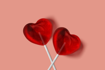 Two heart lollypops on pink background - Love and sweetness concept