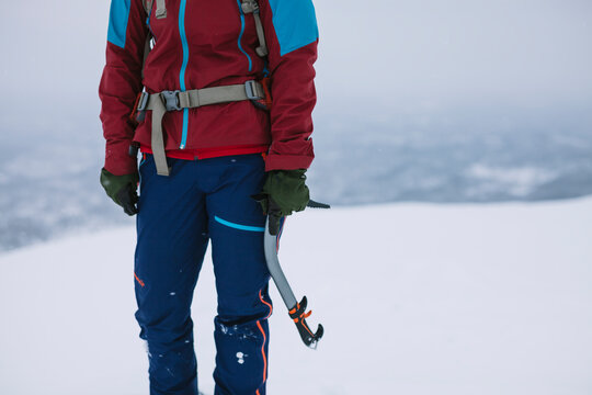 Woman holding ice climbing gear
