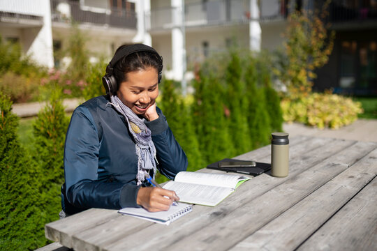Young woman learning at courtyard