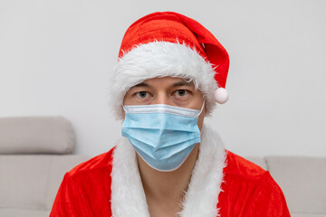 portrait man in Santa Claus hat and face mask
