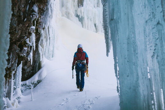 Female ice climber walking on snow