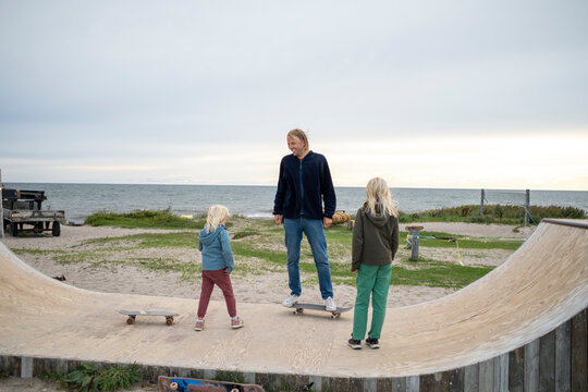 Father with children at skateboard ramp