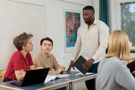 Teacher helping students in classroom