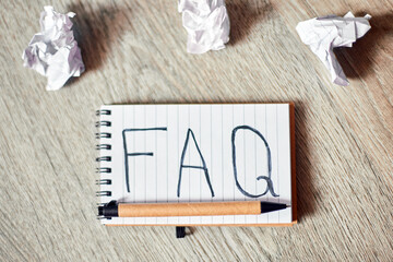 Faq, frequently asked questions text on notebook .on wooden  background, Social Online Business...