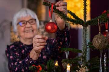 Woman decorating Christmas tree