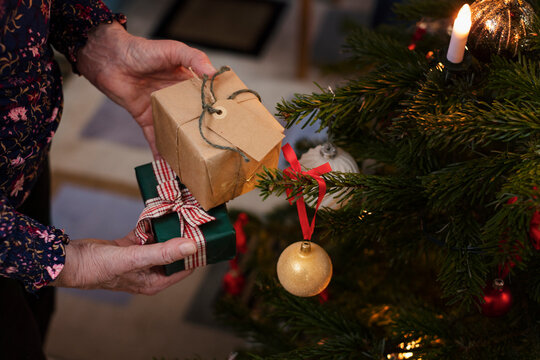 Woman's hands holding Christmas presents