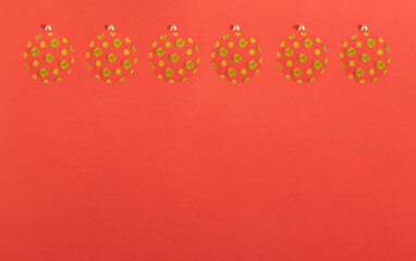 Six in a rowChristmas bauble made of gold glitter paper decoration on red background. Shiny  New Year party concept.  Minimal flat lay.