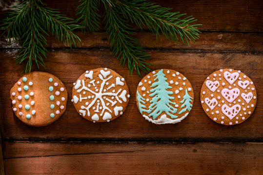 Christmas cookies with icing on wooden background