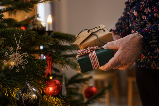 Woman's hands holding Christmas presents