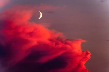 Crescent moon and red clouds