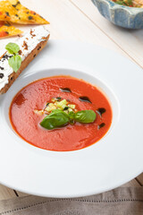 tomato soup in a bowl on white background