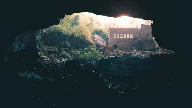 MERSIN, TURKEY, NOVEMBER 17, 2021: People visiting the cave near Cennet (Heaven) Sinkhole, one of the two large sinkholes (the other is Hell) in the Taurus Mountains, in Mersin Province, Turkey.