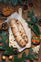 Dough for Christmas stollen with Christmas decorations on wooden background