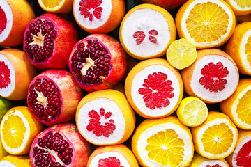 Assortment of exotic fruits close-up. Pomegranate, orange and lemon fruits in the street of market.