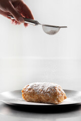 Napoleon cake with icing sugar  . Decorating napoleon cake with powdered sugar.