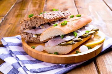 Dutch herring. Toast with Dutch herring, onions, pickles. Traditional rustic appetizer with seafood. Popular food in the netherlands. for social networks. Copy space