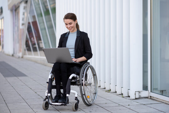 Disabled businesswoman in a wheelchair working outside