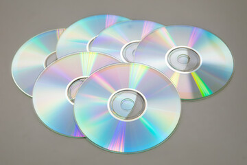 Six CDs DVDs on a gray background.