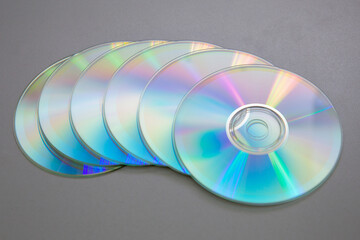 Six CDs DVDs on a gray background.