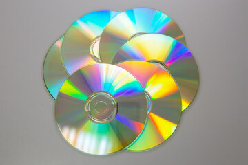 Six CDs DVDs on a gray background.