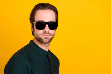 Fototapeta premium Photo of confident cool young guy dressed smart casual clothes dark eyewear empty space isolated yellow color background