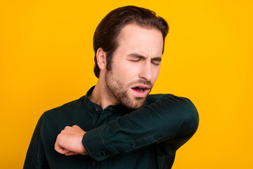 Photo of sad ill young guy dressed smart casual clothes sneezing isolated yellow color background