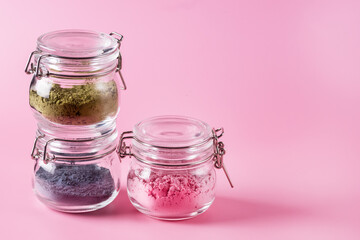 Different of japanese matcha tea green red and blue in glass jars on Pink Background Acai Berry Powder green tea leaf powder clitoria flower powder copy space