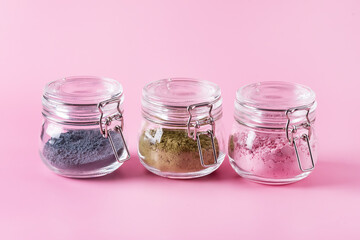 Different of japanese matcha tea green red and blue in glass jars on Pink Background Acai Berry Powder green tea leaf powder clitoria flower powder horizontal