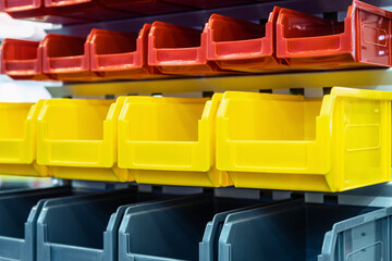 plastic boxes of different colors used in warehouses