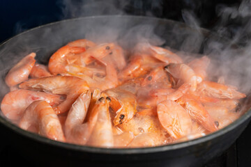 Fried shrimp on a frying pan. Healthy Sea Food, Seafood, Shrimp Cooking, Close-up. Asian Cuisine.