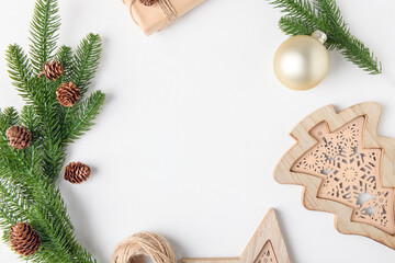 Christmas background frame of fir twigs, wooden zero waste home decoration: balls, pine and...