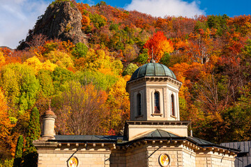 Obraz premium Stanisoara Monastery, built in the 18th century, is a orthodox religious landmark from Cozia Mountains and Romania. Photo taken in the autumn landscape.