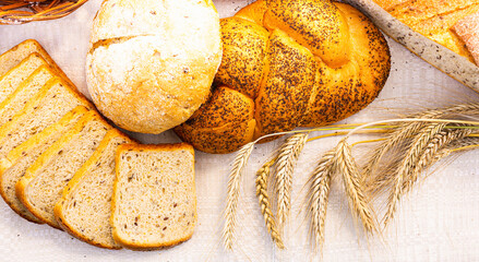lot of different flavored bread, wheat, rye, on the table in the field outside