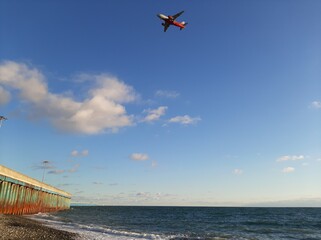 A small red plane in a blue sky